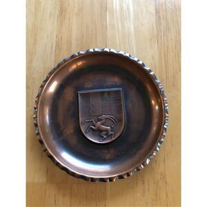 Sigg Switzerland vintage hanging decorative plate brass color 5”